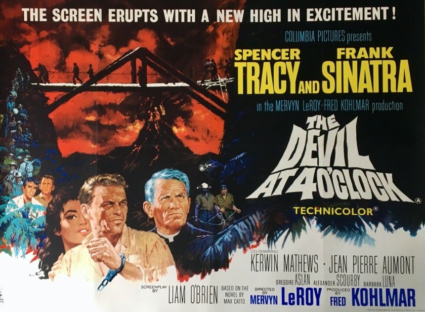 The theatrical poster for the film The Devil At 4 O'Clock, highlighting the stars Spencer Tracy and Frank Sinatra, with an artwork of the two below a silhouette of a bridge against a red sky and the distant volcano, referencing the film's climax