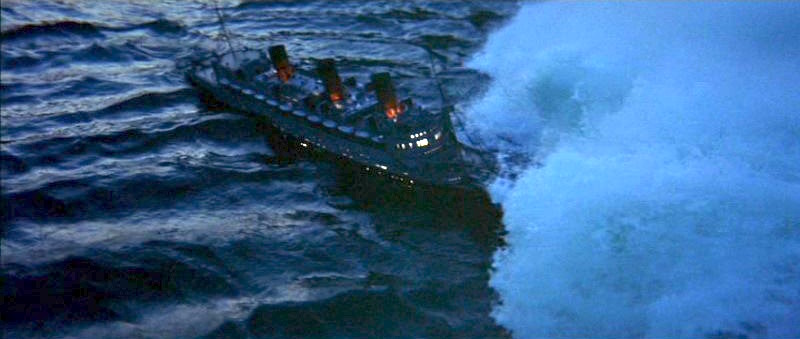 The moment from The Poseidon Adventure when the liner is struck by the tidal wave. The ship is at a three-quarter angle, on the starboard bow, while the foaming wave comes in from the right. The lighting suggests evening 'blue hour'
